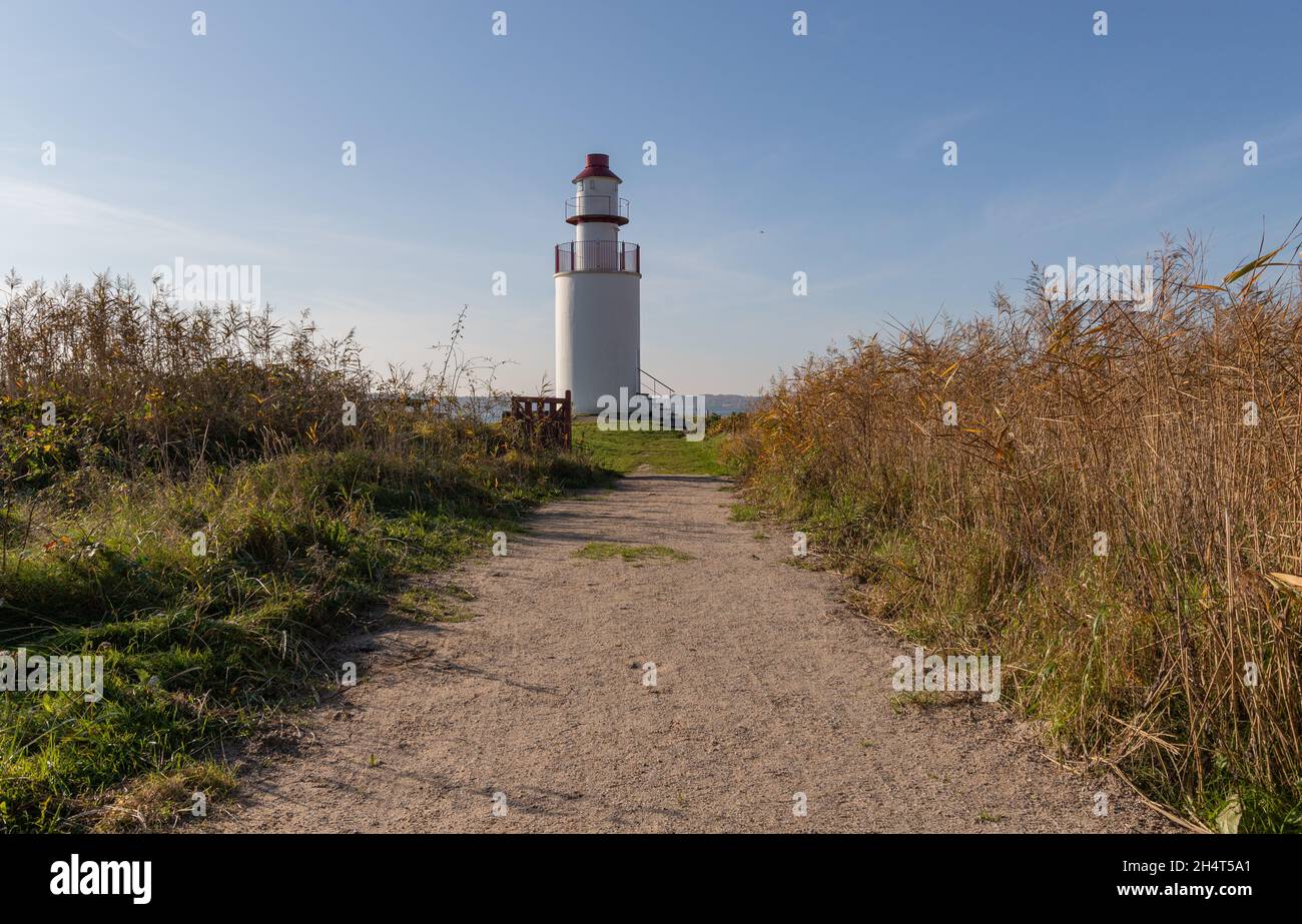 Stouby, Denmark - October 29, 2021: White Traeskohage lighthouse at the northern side of Vejle Fjord Stock Photo