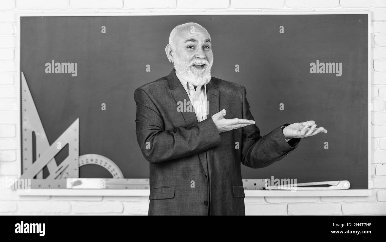 presenting product. get knowledge here. senior man teacher use math