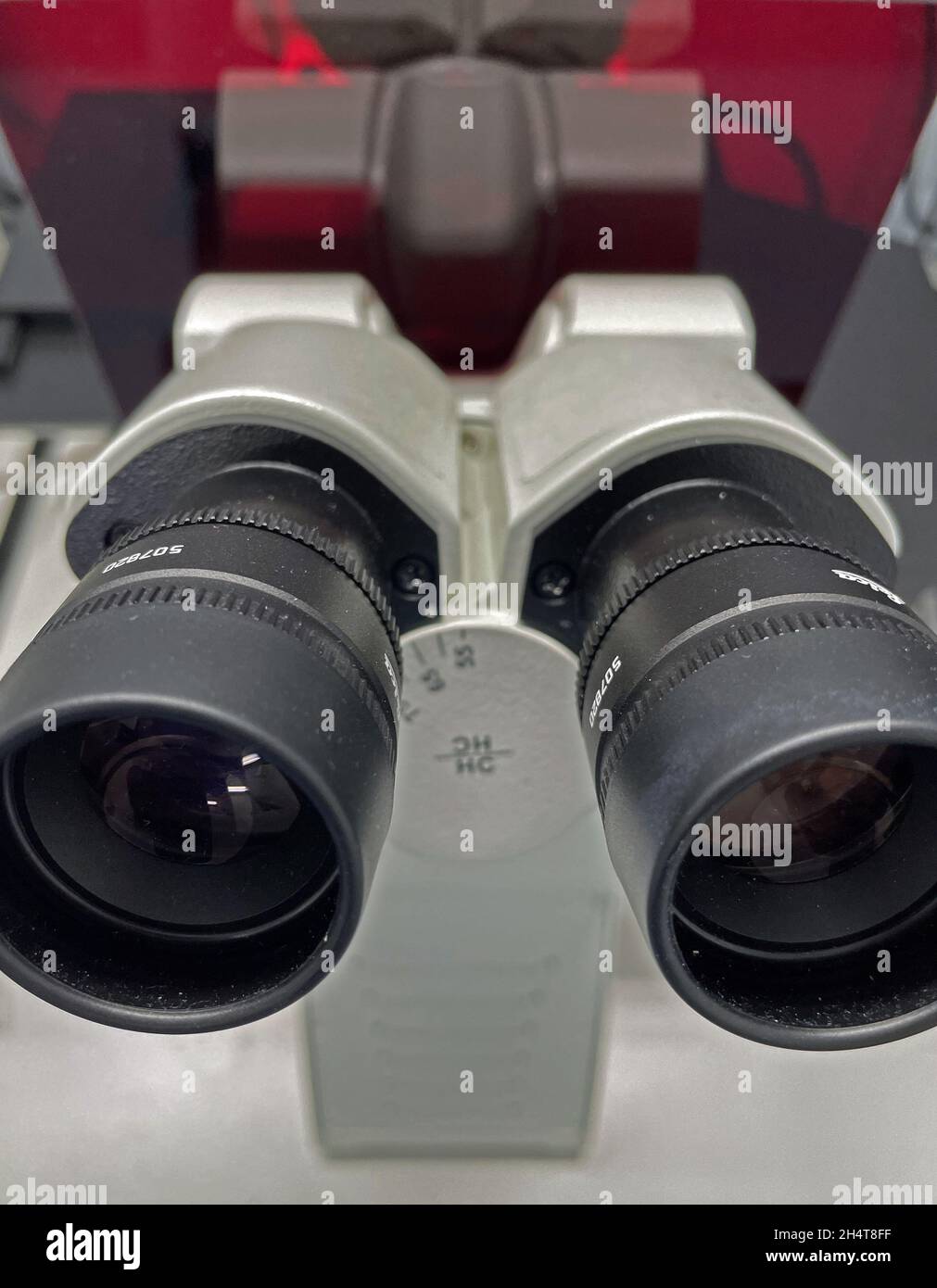 Vertical closeup shot of ocular lens eyepiece of microscope Stock