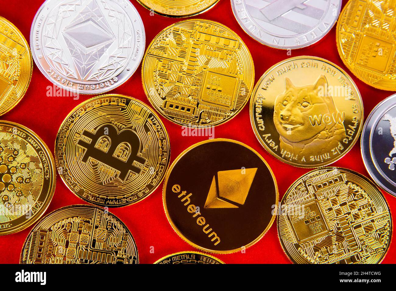 Selection of cryptocurrency token coins including ethereum, bitcoin, ripple, dogecoin, cardano and litecoin background Stock Photo