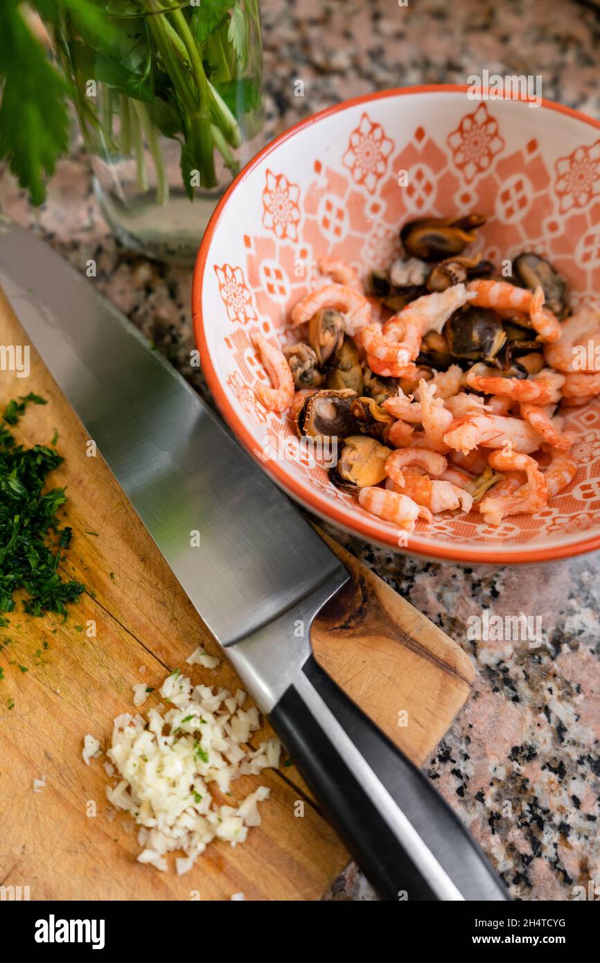 Vertical shot of ingredients to prepare seafood Provencal Stock Photo