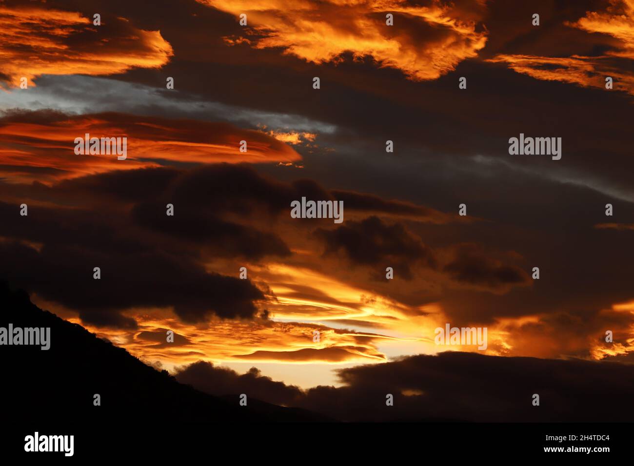 Dramatic sunset above the mountains and explosion of colors Stock Photo ...