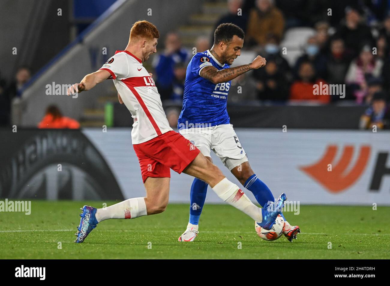 Ryan Bertrand #5 of Leicester City is tackled by Maximiliano Caufriez (3) of Spartak Moscow Stock Photo