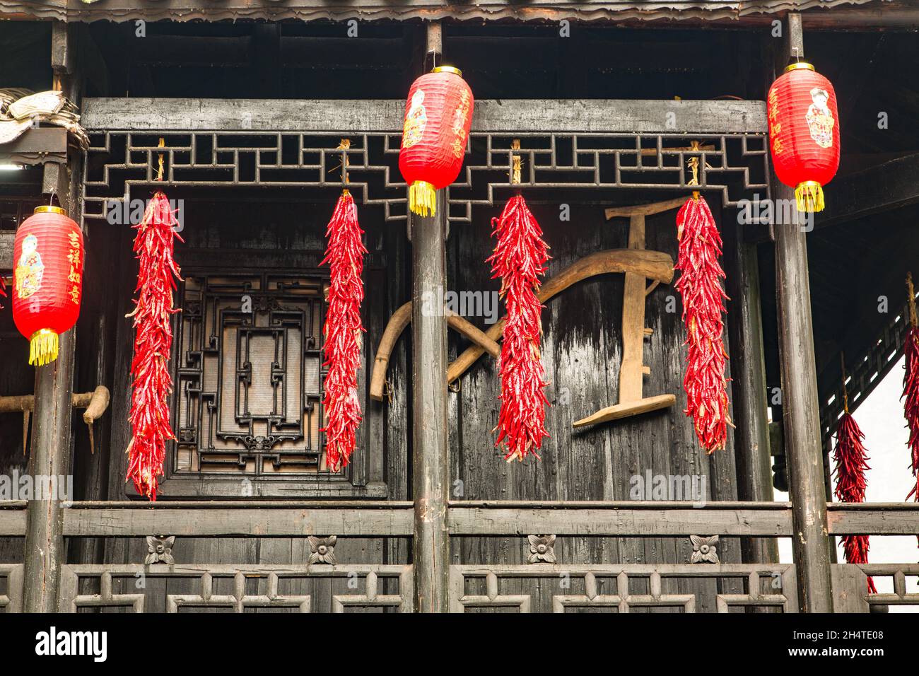 Strands of red chili peppers and Chinese lanterns on a traditional wooden  building in Zhangjiajie National Forest Park, Hunan, China Stock Photo -  Alamy, image size:1300x956