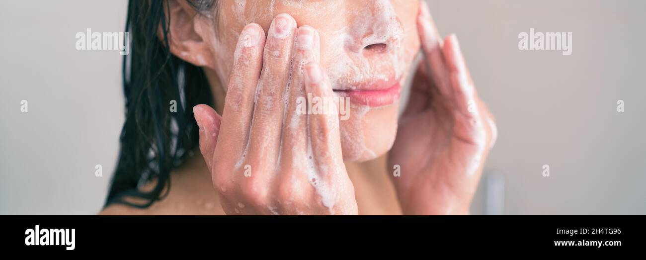 Face wash exfoliation scrub soap woman washing scrubbing with skincare cleansing product panoramic banner. Stock Photo