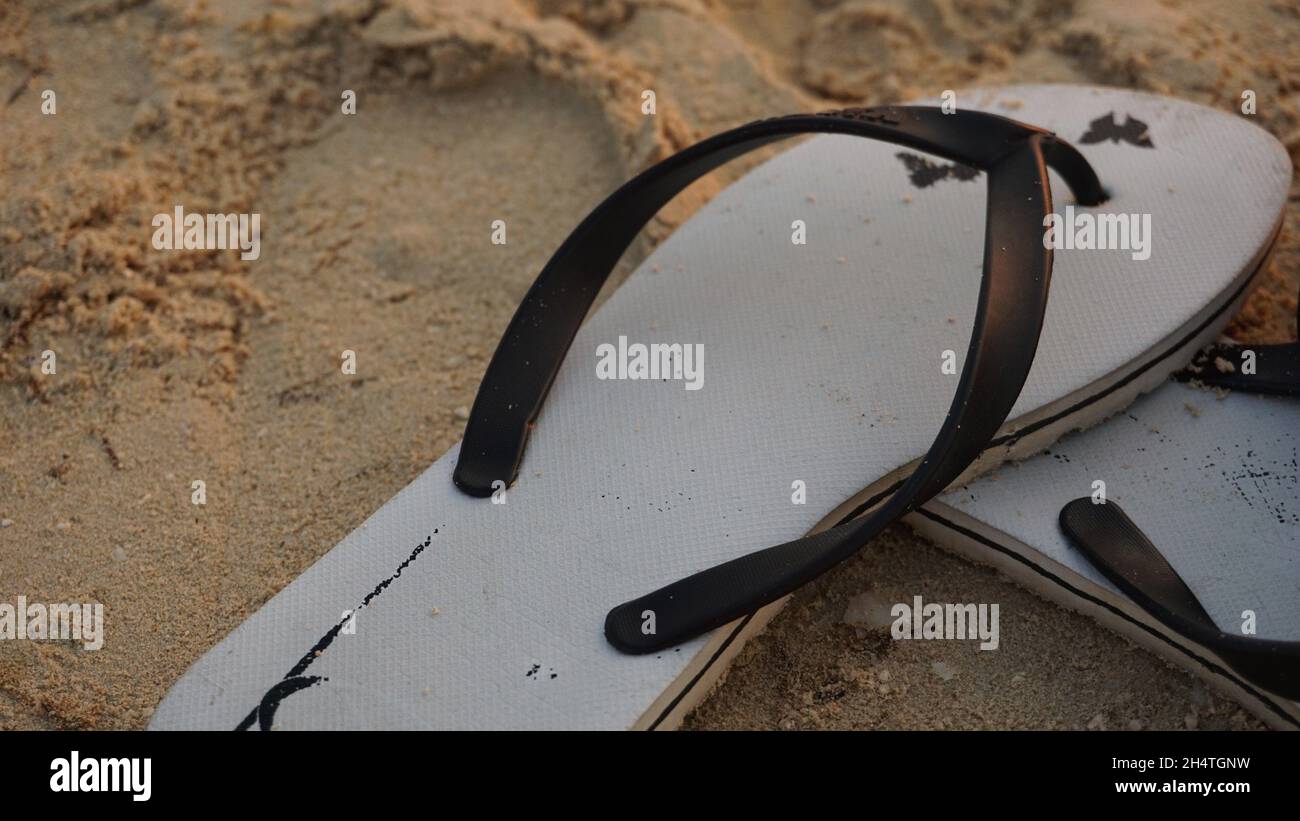 Pair of flip flops on the sandy beach Stock Photo - Alamy