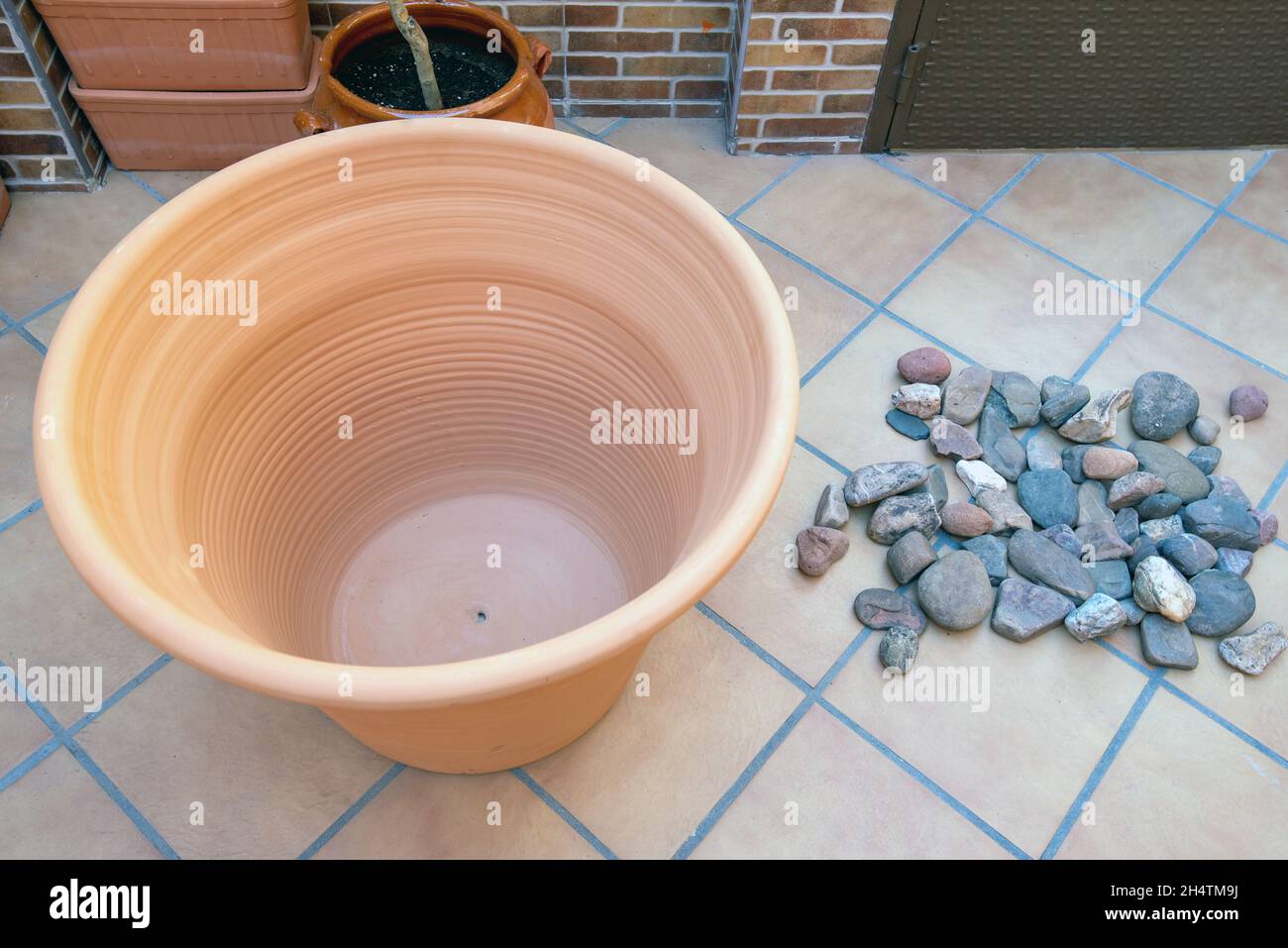 Large pot with nothing in it and many stones. Stock Photo