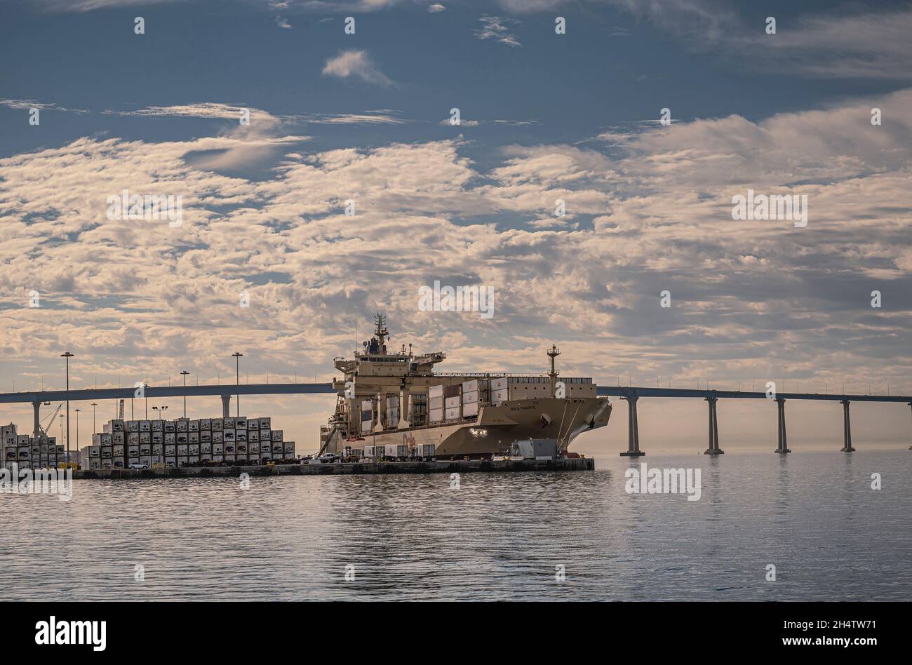 San Diego, California, USA - October 4, 2021: Dole Pacific container ship docked at ILWU terminal. Refrigerated boxes are unloaded under blue cloudsca Stock Photo