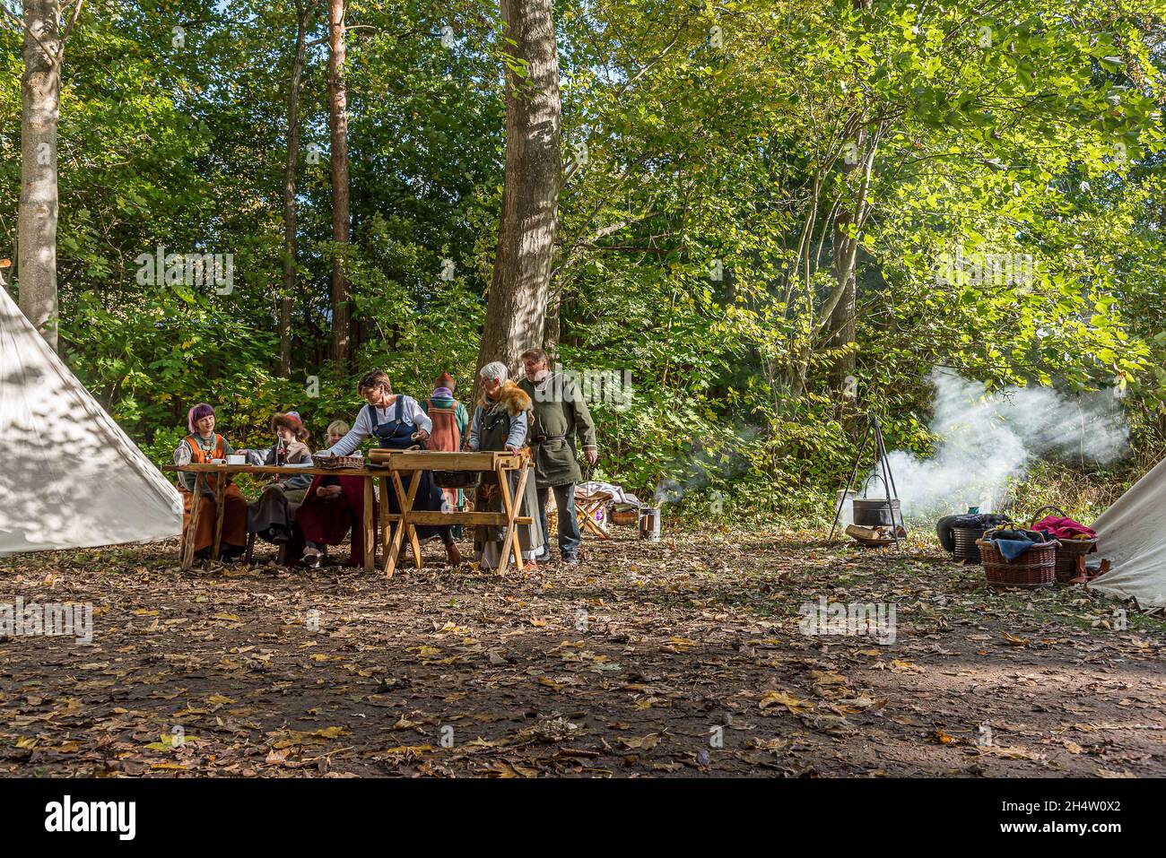 family cooking over an open fire and having dinner at the Viking Market in Frederikssund, October 23, 2021 Stock Photo