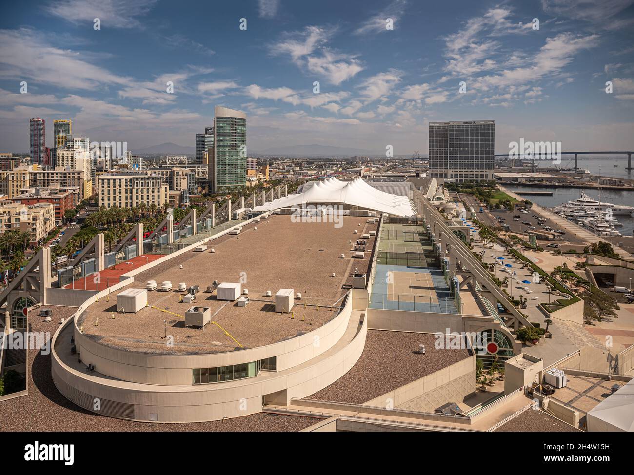 San Diego, California, USA - October 4, 2021: Aerial view on convention center with Hilton Bayfront hotel in back under blue cloudscape, More building Stock Photo