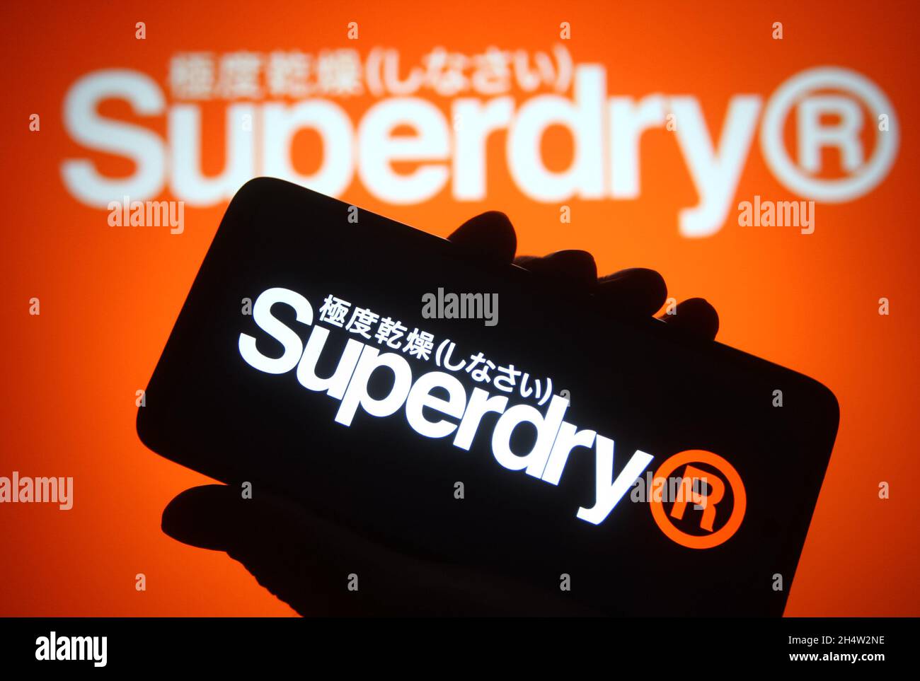 In this photo illustration a Superdry plc logo of a UK branded clothing