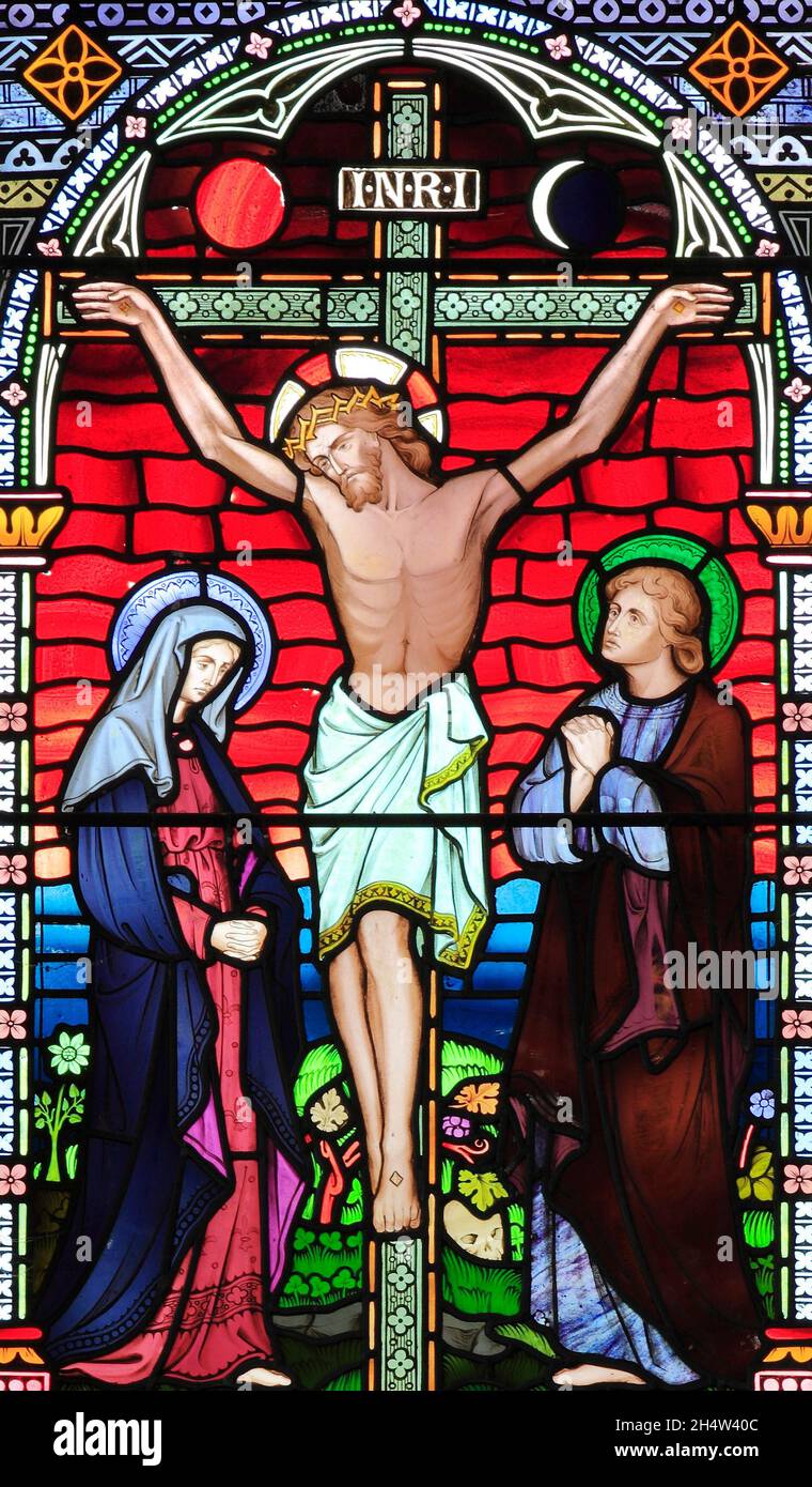 The Crucifixion of Jesus, with Mary and John, Old Hunstanton, detail of stained glass window by Frederick Preedy, 1867, Norfolk, England Stock Photo
