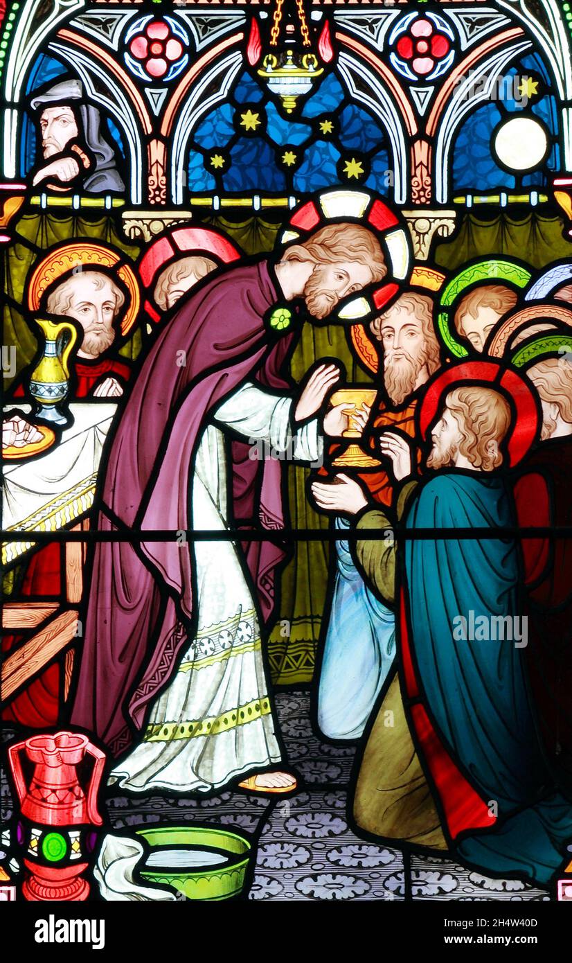 The Last Supper, Jesus offers wine to disciple, Old Hunstanton, detail of stained glass window by Frederick Preedy, 1867, Judas with bag of si lurks Stock Photo