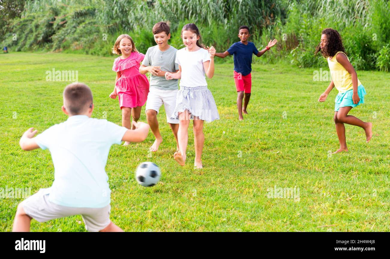 summer tween Cheerful tween friends playing with ball outdoors in summer Stock Photo -  Alamy