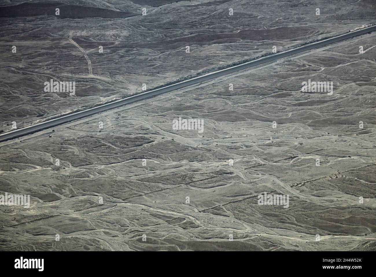 Dry waterways and Pan-American Highway near Nazca, Ica Region, Peru, South America - aerial Stock Photo