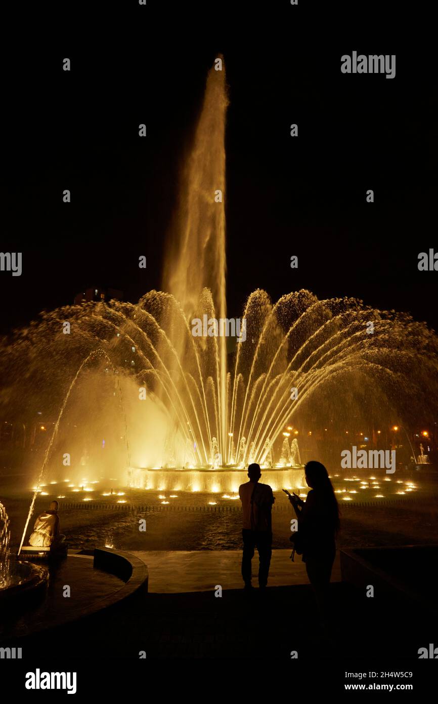 Tourists at the Magic Fountain at the Magic Water Circuit (world's largest fountain complex) Park of the Reserve, Lima, Peru, South America Stock Photo