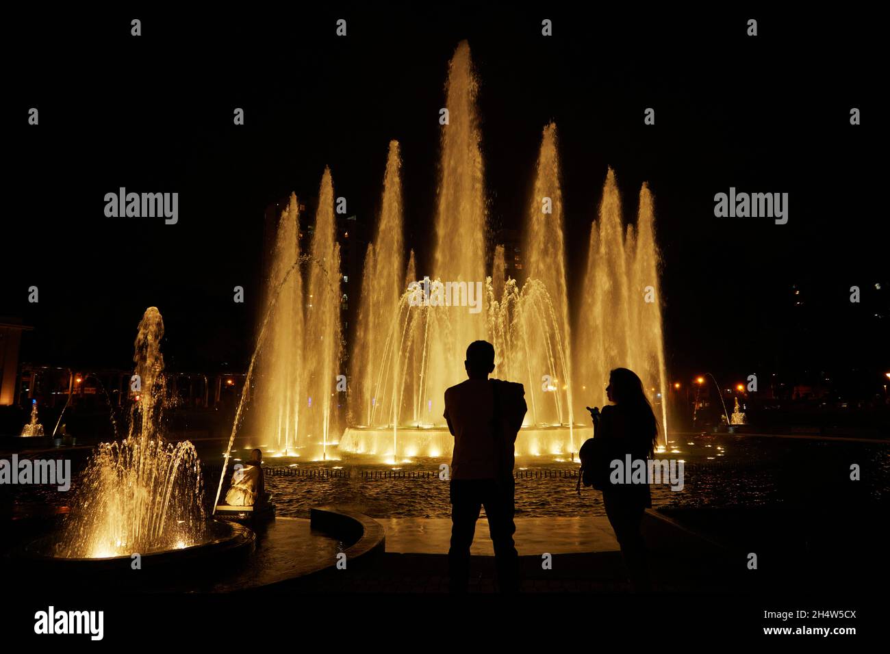 Tourists at the Magic Fountain at the Magic Water Circuit (world's largest fountain complex) Park of the Reserve, Lima, Peru, South America Stock Photo