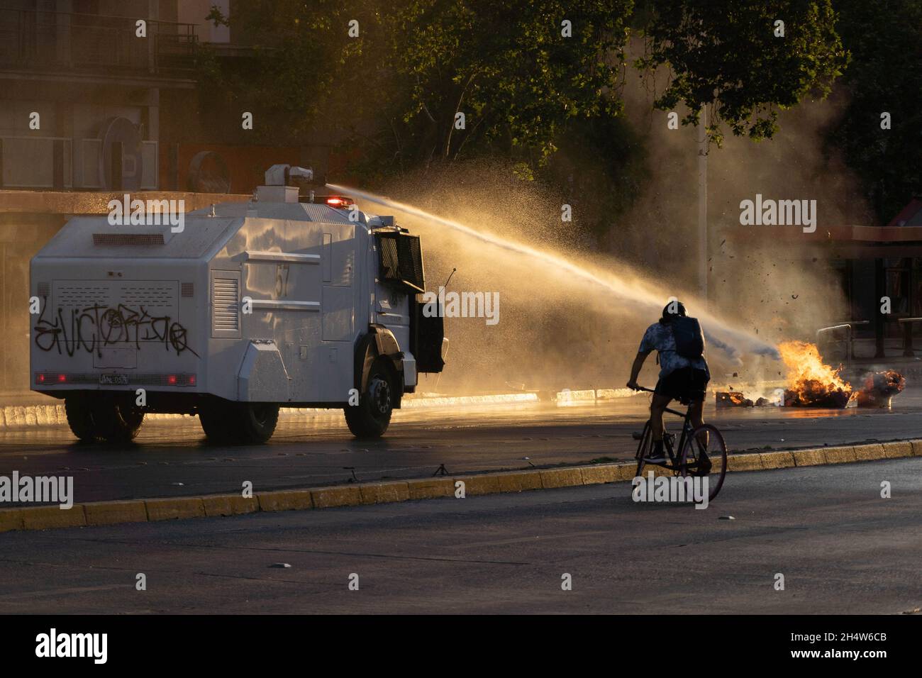 Santiago, Metropolitana, Chile. 4th Nov, 2021. Police use the water cannon to put out a barricade during protests against the government of Sebastian Pinera, in Santiago, Chile. The protests come after the death of a Mapuche person during clashes in the southern region of Bio Bio after the Chilean government declared a state of emergency to reduce violence in that area of southern Chile. (Credit Image: © Matias Basualdo/ZUMA Press Wire) Stock Photo