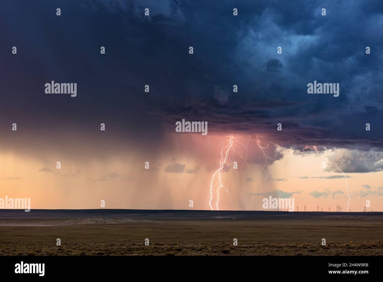 Thunderstorm and lightning strike with sunset sky near Vaughn, New Mexico Stock Photo