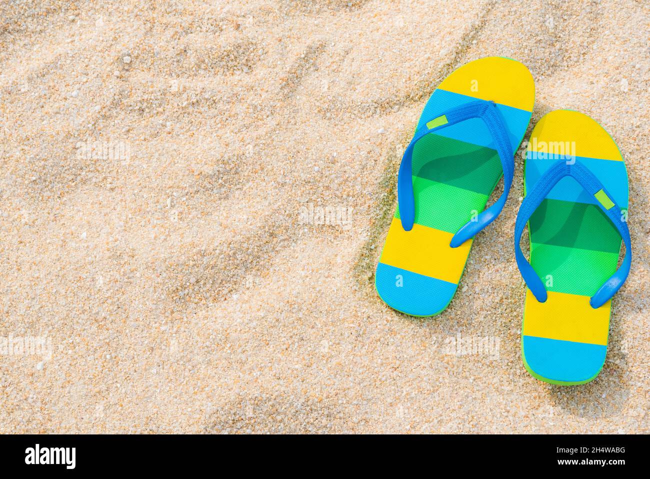 Pair of sandals on sandy beach hi-res stock photography and images - Alamy
