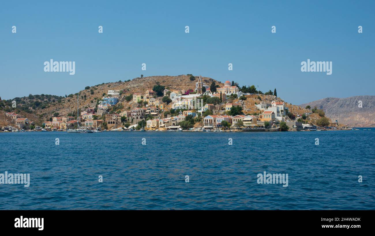 Beautiful view from the water of colorful Symi island in summer. Dodecanese, Greece Stock Photo