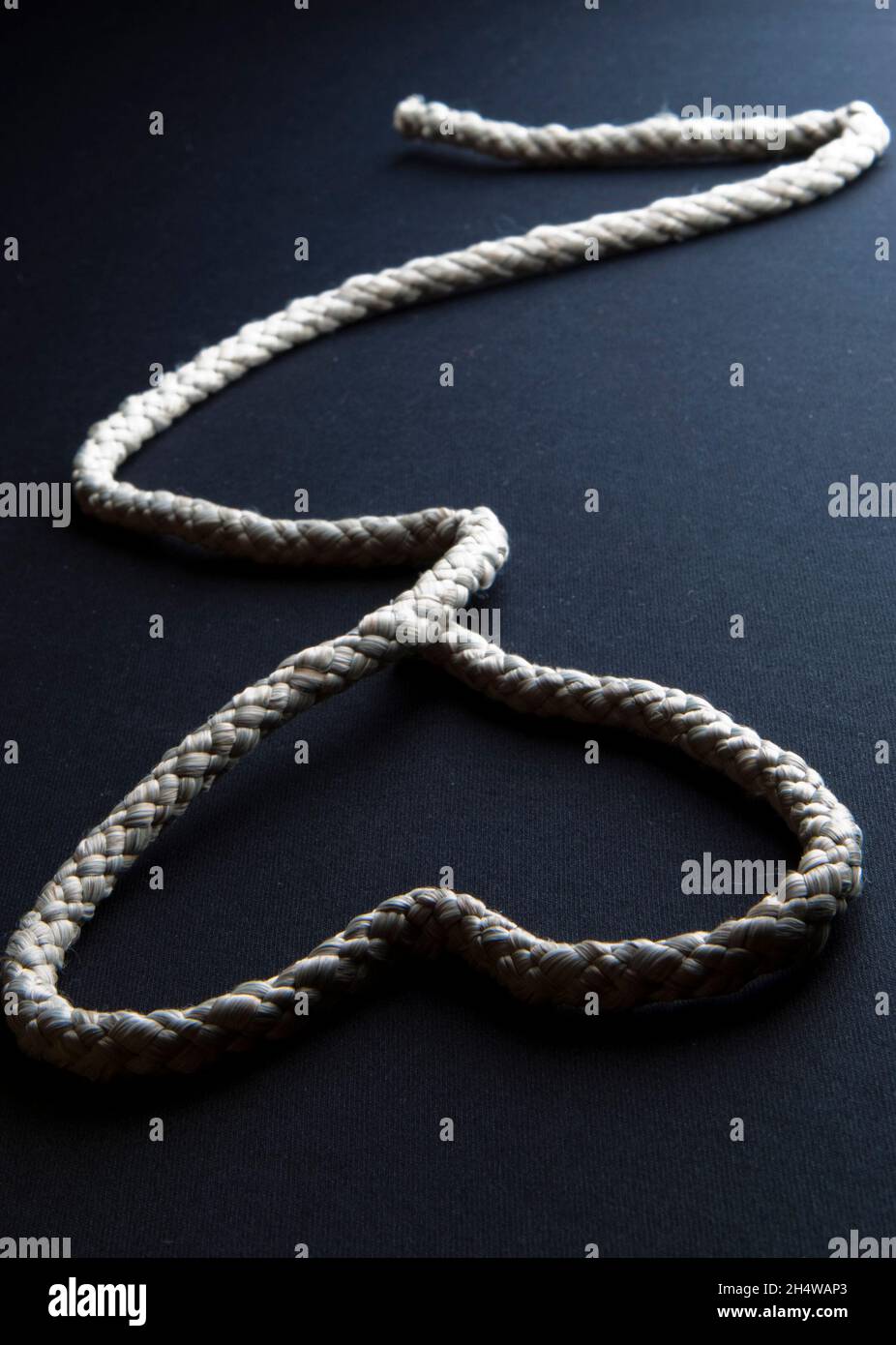 Heart shape with a rope. Black background Stock Photo - Alamy