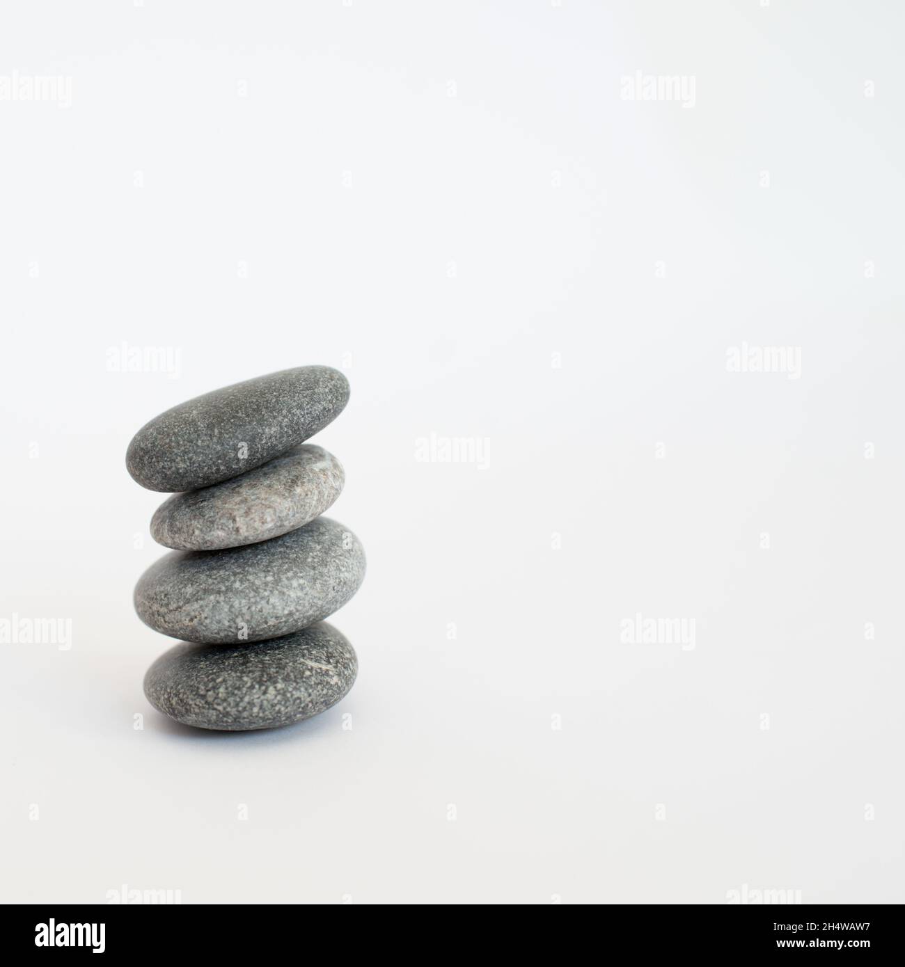 4 Piled Rocks Pile of four stones with white background Stock Photo - Alamy