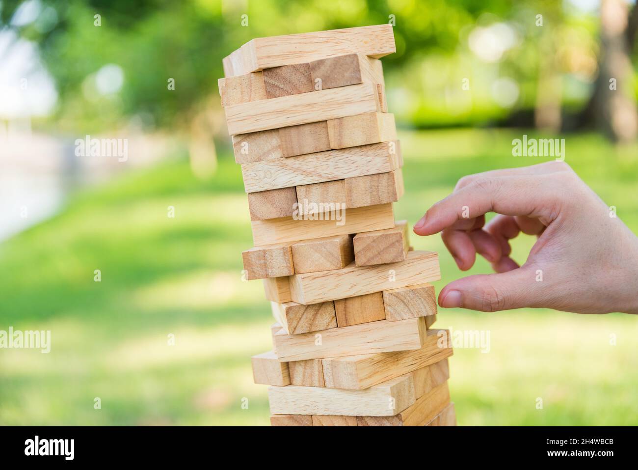 Close up hand man playing block wood stack game Stock Photo - Alamy