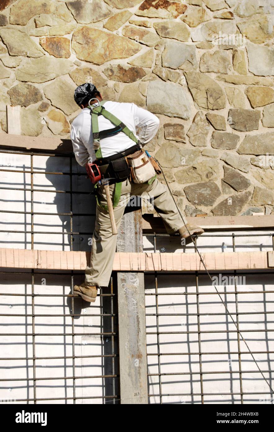 Construction worker preparing a soldier pile retaining wall for shotcrete Stock Photo
