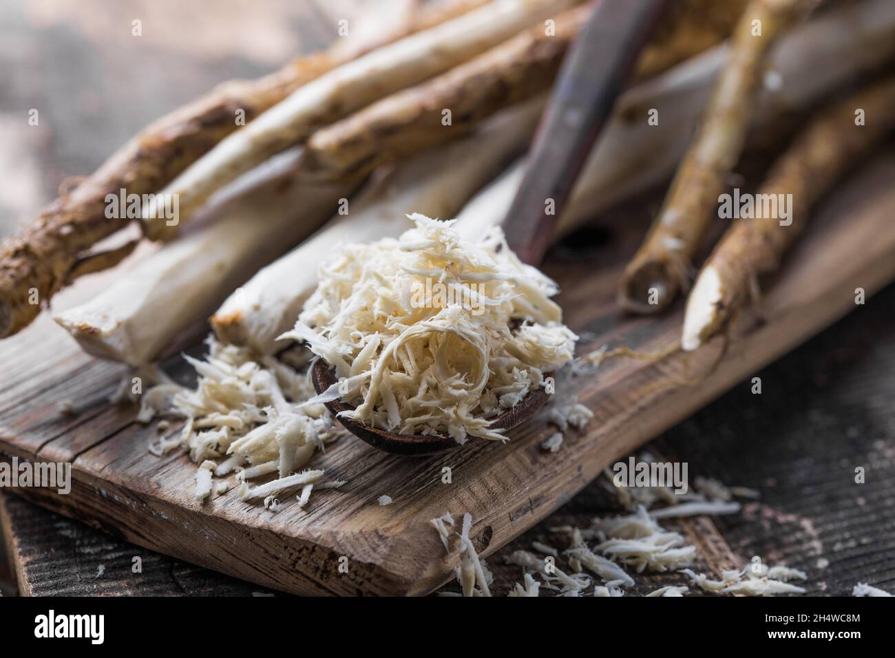 Fresh organic horseradish or Horse-radish root on wooden cutting board ...