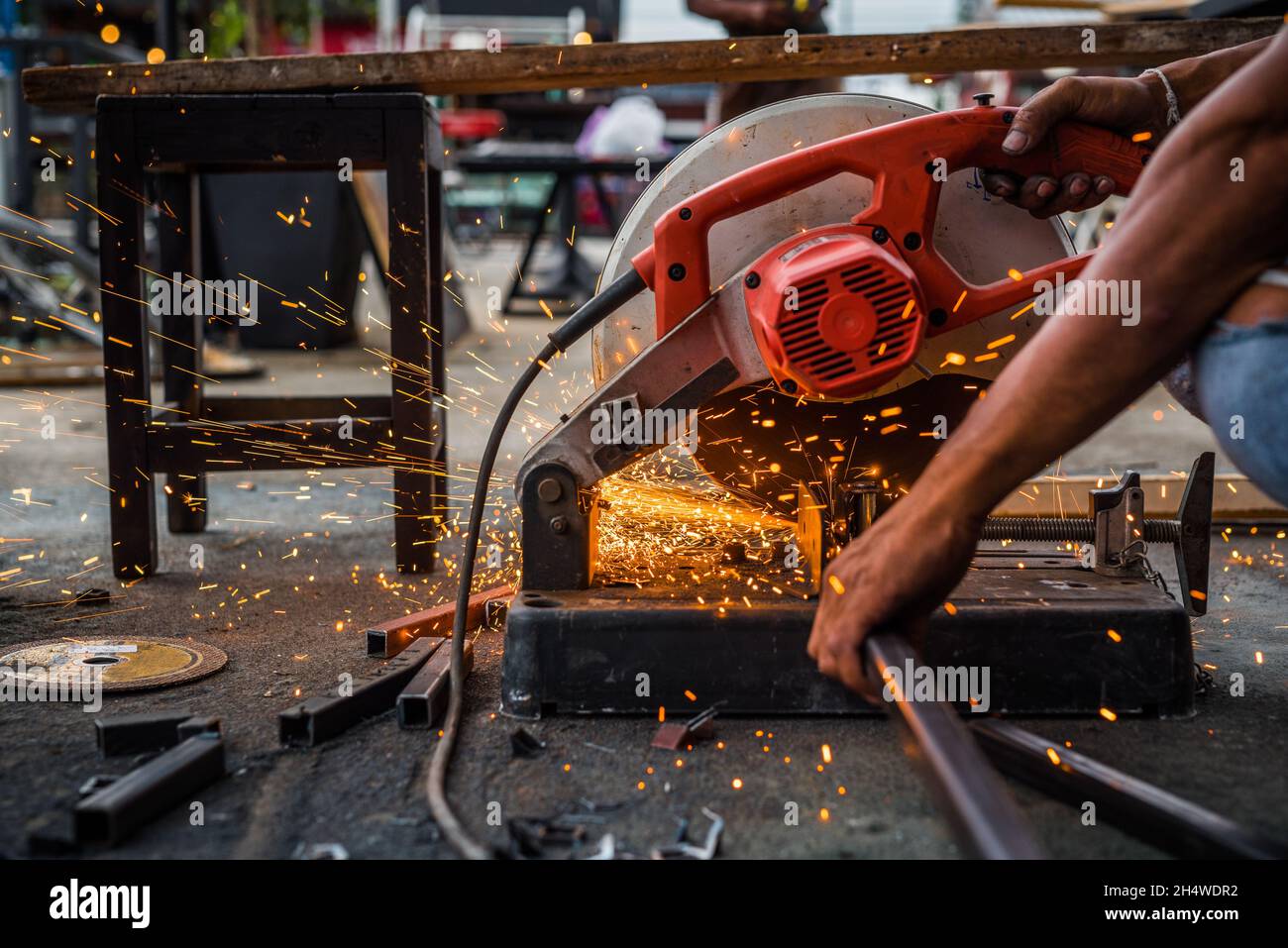 Worker man using machine cutting steel Stock Photo - Alamy