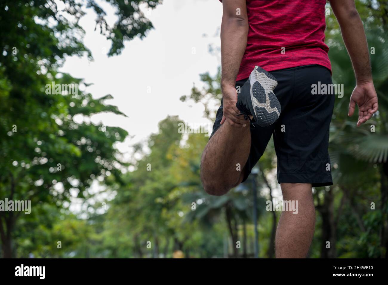 Young Fitness Man Runner Stretching Before Run Healthy Lifestyle And