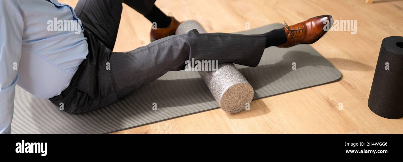 Foam Roller Calves Treatment And Muscle Pressure Release Stock Photo