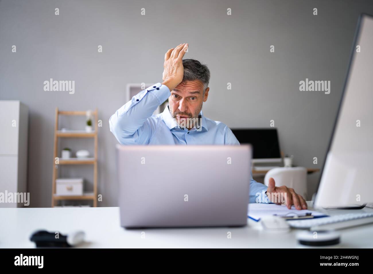 Computer Laptop Surprise At Workplace. Mature Man Forgot Password Stock Photo