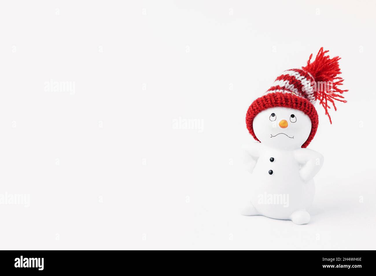 Business important snowman standing isolated on white background. Merry christmas and happy new year greeting card. Funny snowman in hat on snowy back Stock Photo