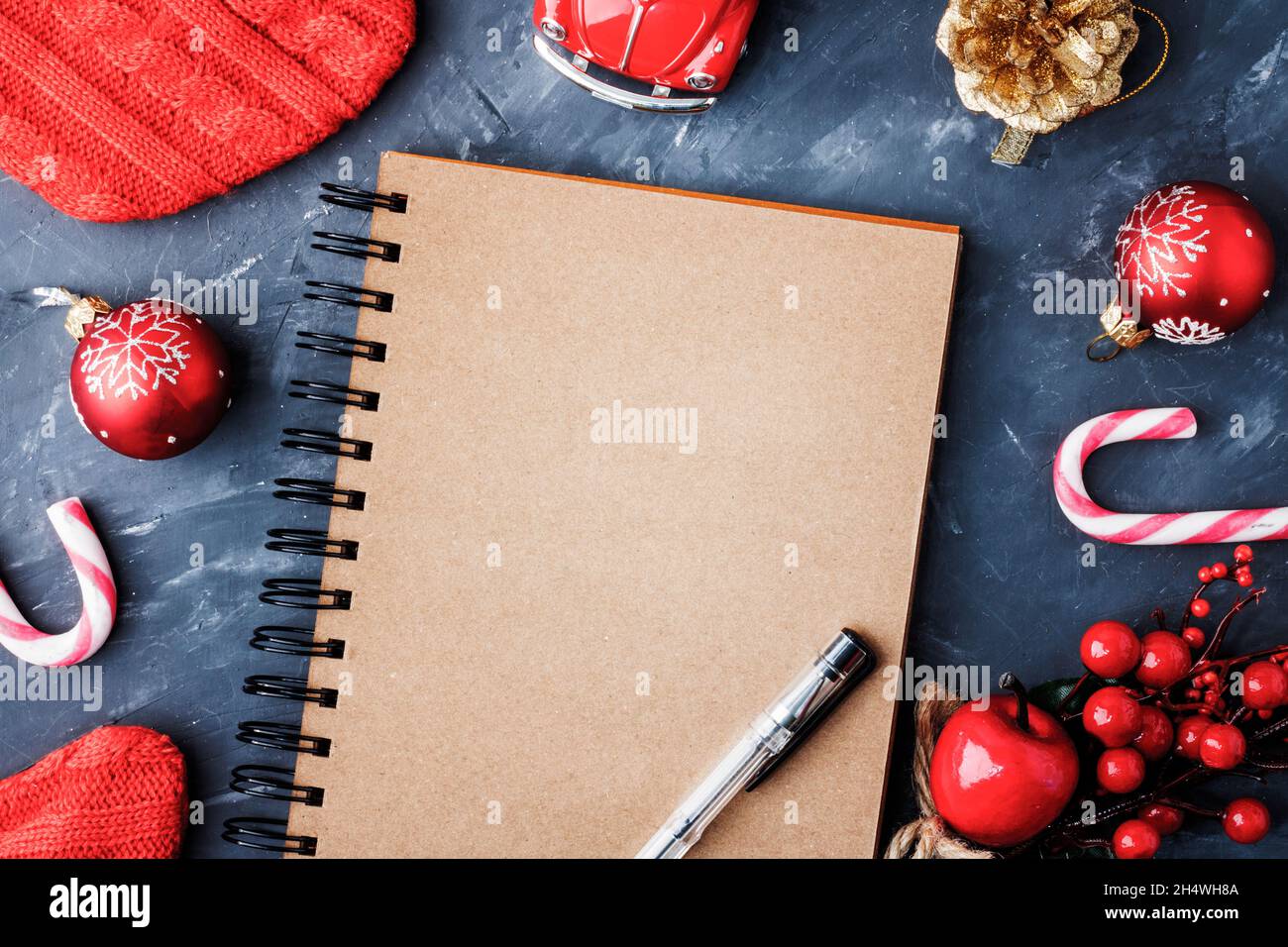 Notebook for records. A blank notebook page on a blue background next to Christmas branches and a Christmas ball. Christmas, New Year's concept. Top v Stock Photo