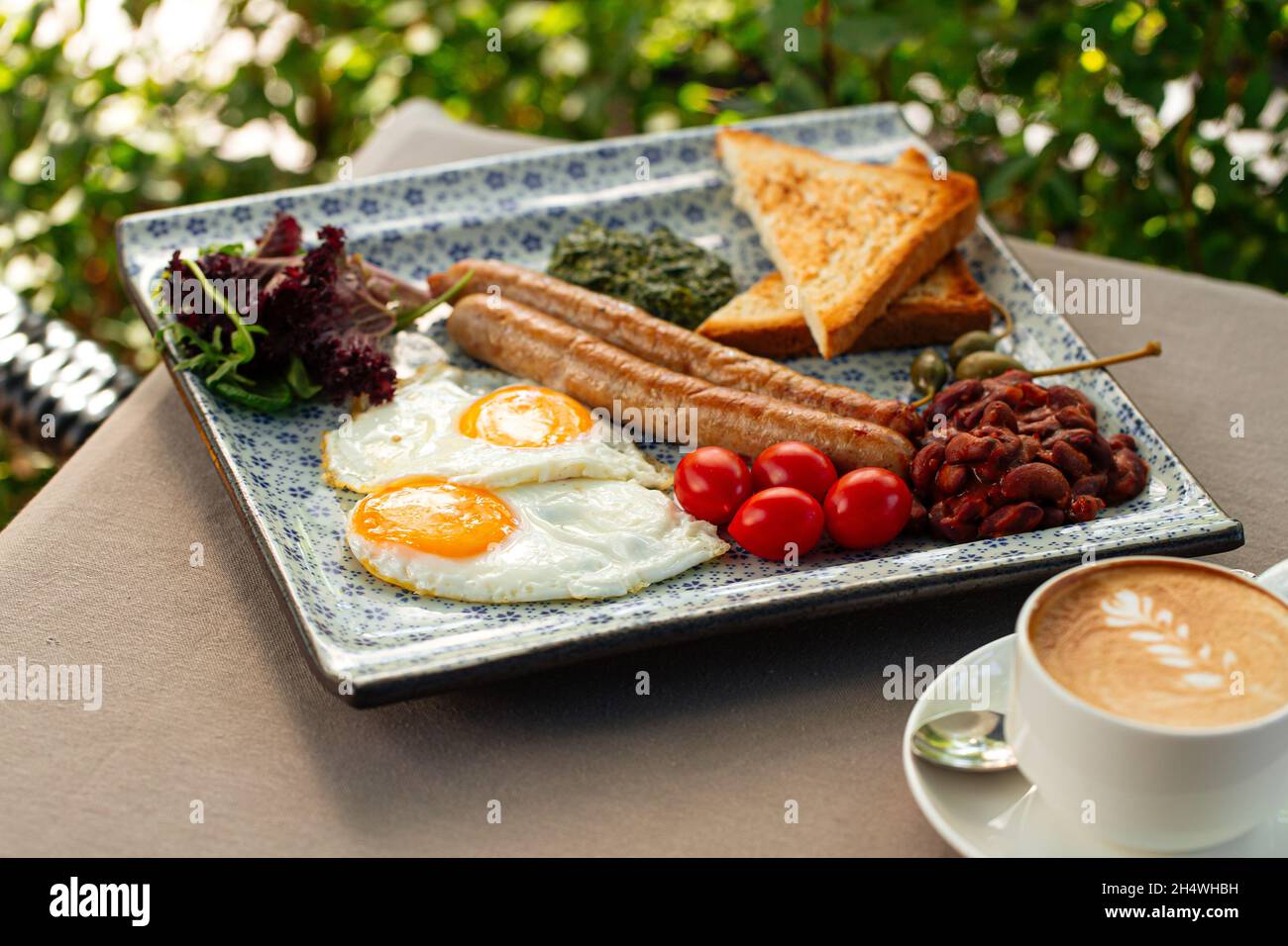 Served english breakfast with cappuccino coffee Stock Photo