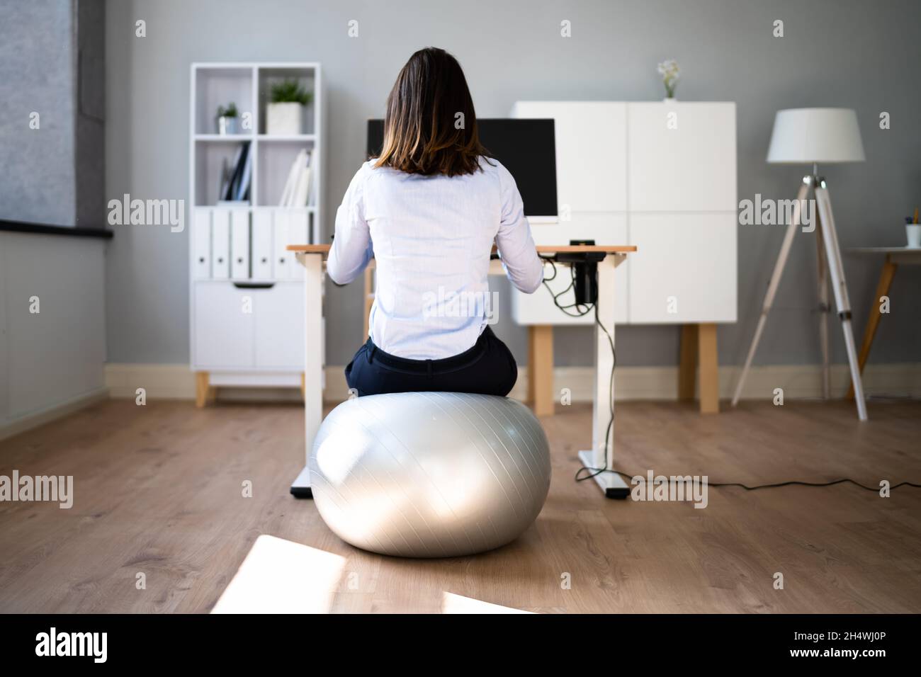 Correct Posture At Desk In Office Using Fitness Ball Stock Photo Alamy