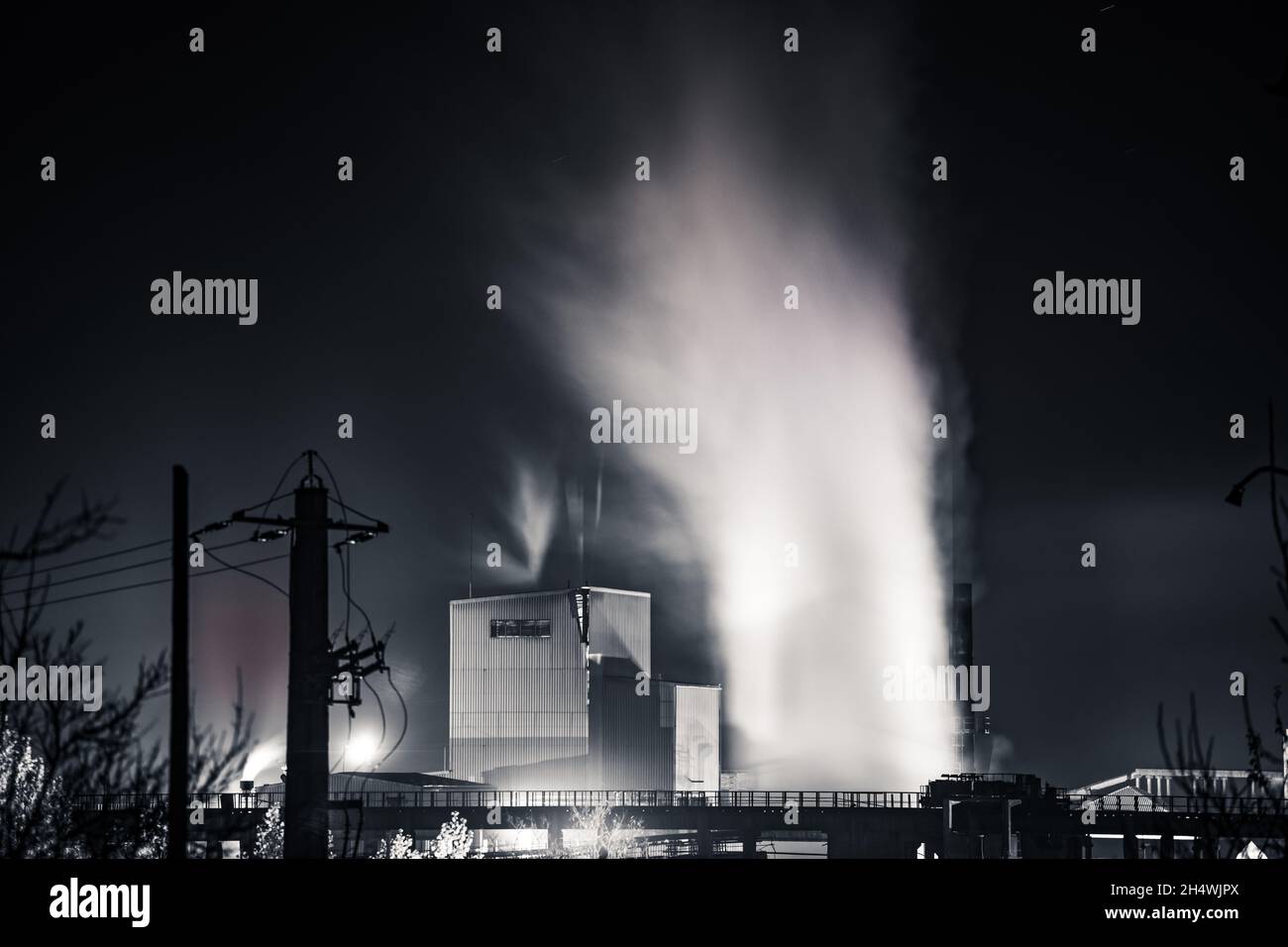 Air pollution from power plant chimneys at night Stock Photo - Alamy