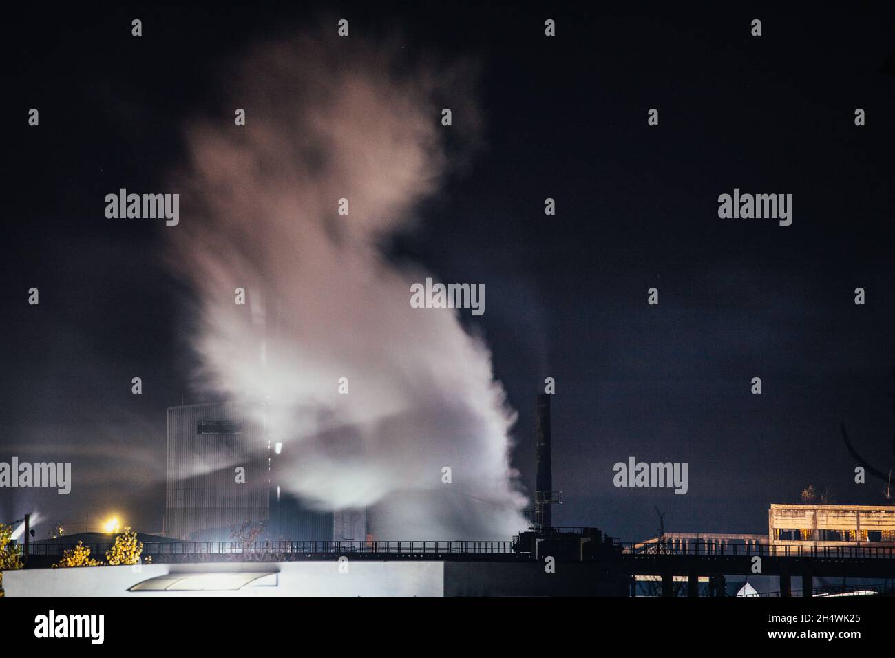 Air pollution from power plant chimneys at night Stock Photo - Alamy