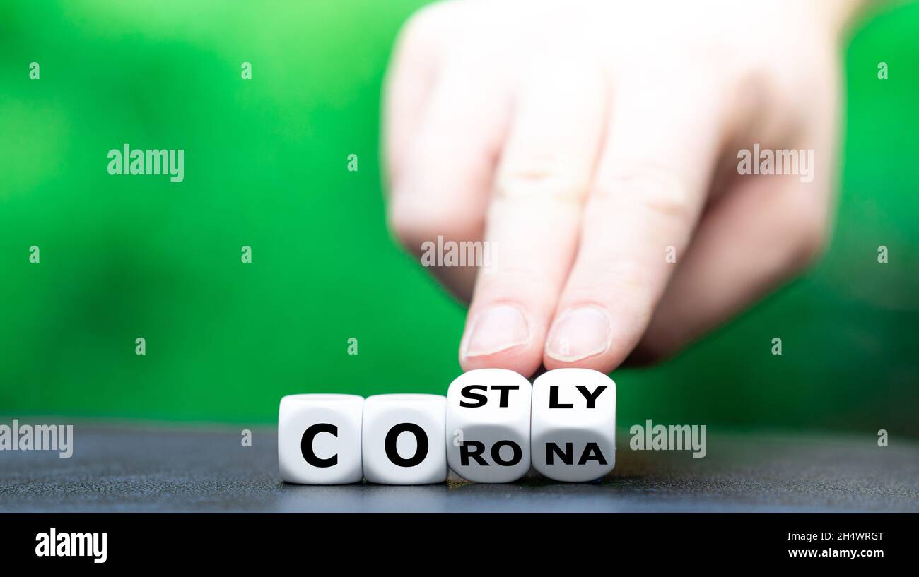 Symbol for costly corona policies. Dice forms the words corona and costly. Stock Photo