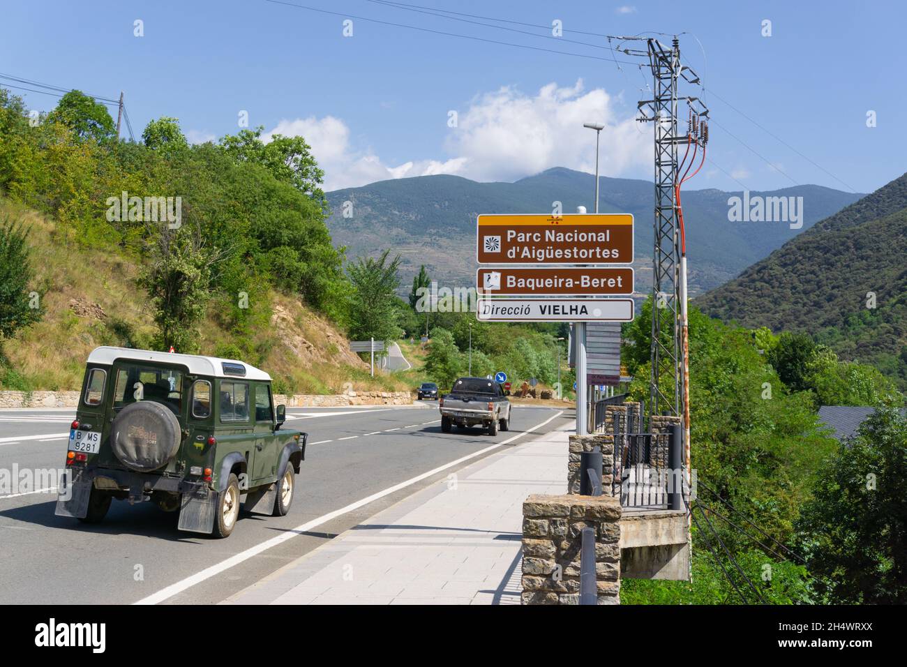 SORT, SPAIN - July 27, 2021: Image of a road between mountains with a traffic sign with different locations towards the town of Vielha in the region o Stock Photo
