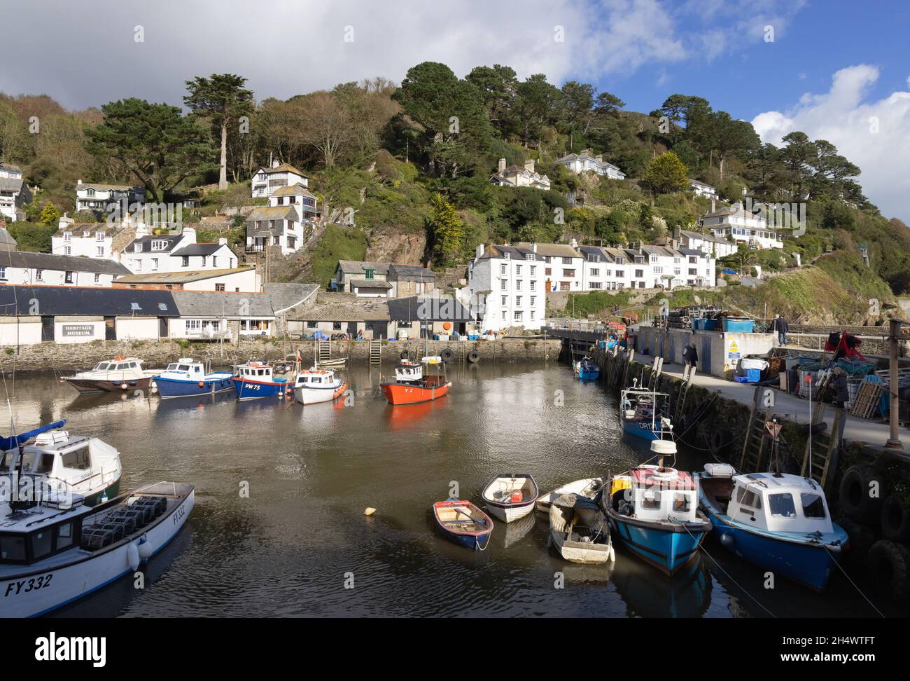 Polperro Cornwall; Polperro harbour with fishing boats on a sunny day in summer, Cornish coast, Cornwall UK Stock Photo