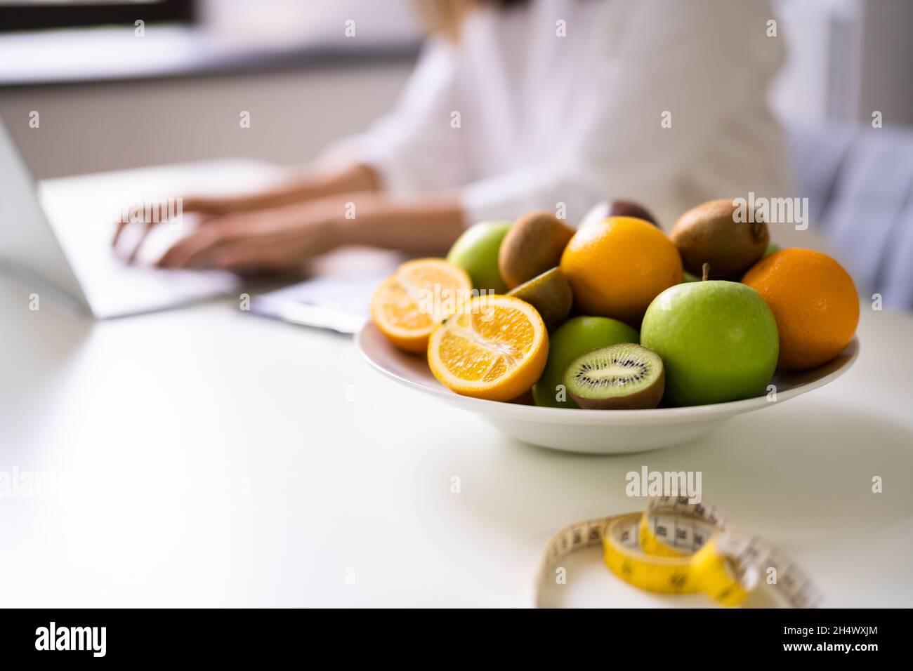 Female Nutritionist Or Dietitian In Laboratory Using Laptop Stock Photo