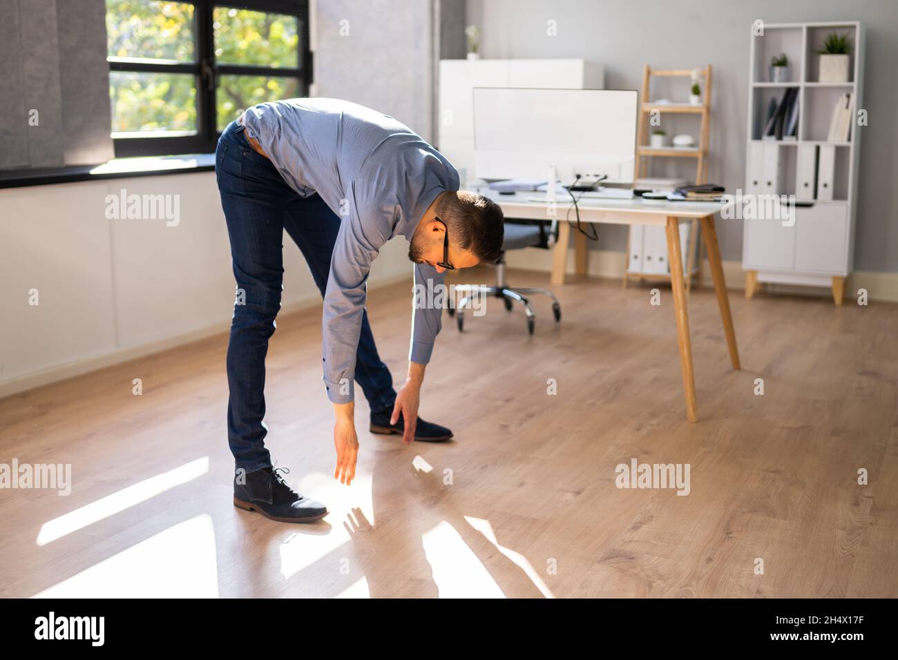 Stretching Exercise Standing In Front Of Computer Stock Photo