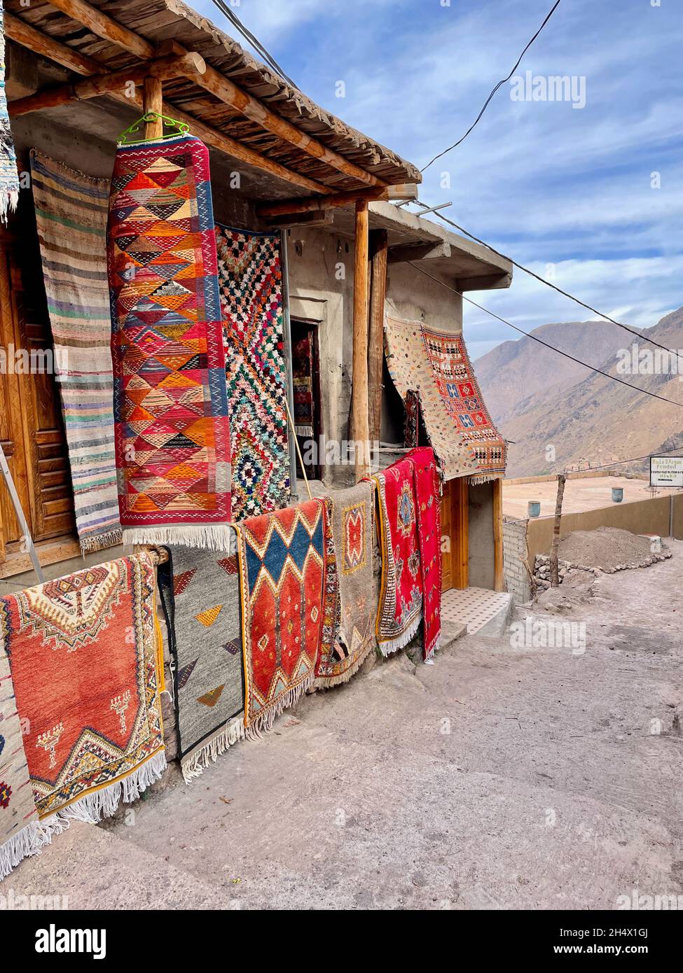 Colorful Berber carpets hanging on display at Moroccan shop in the High