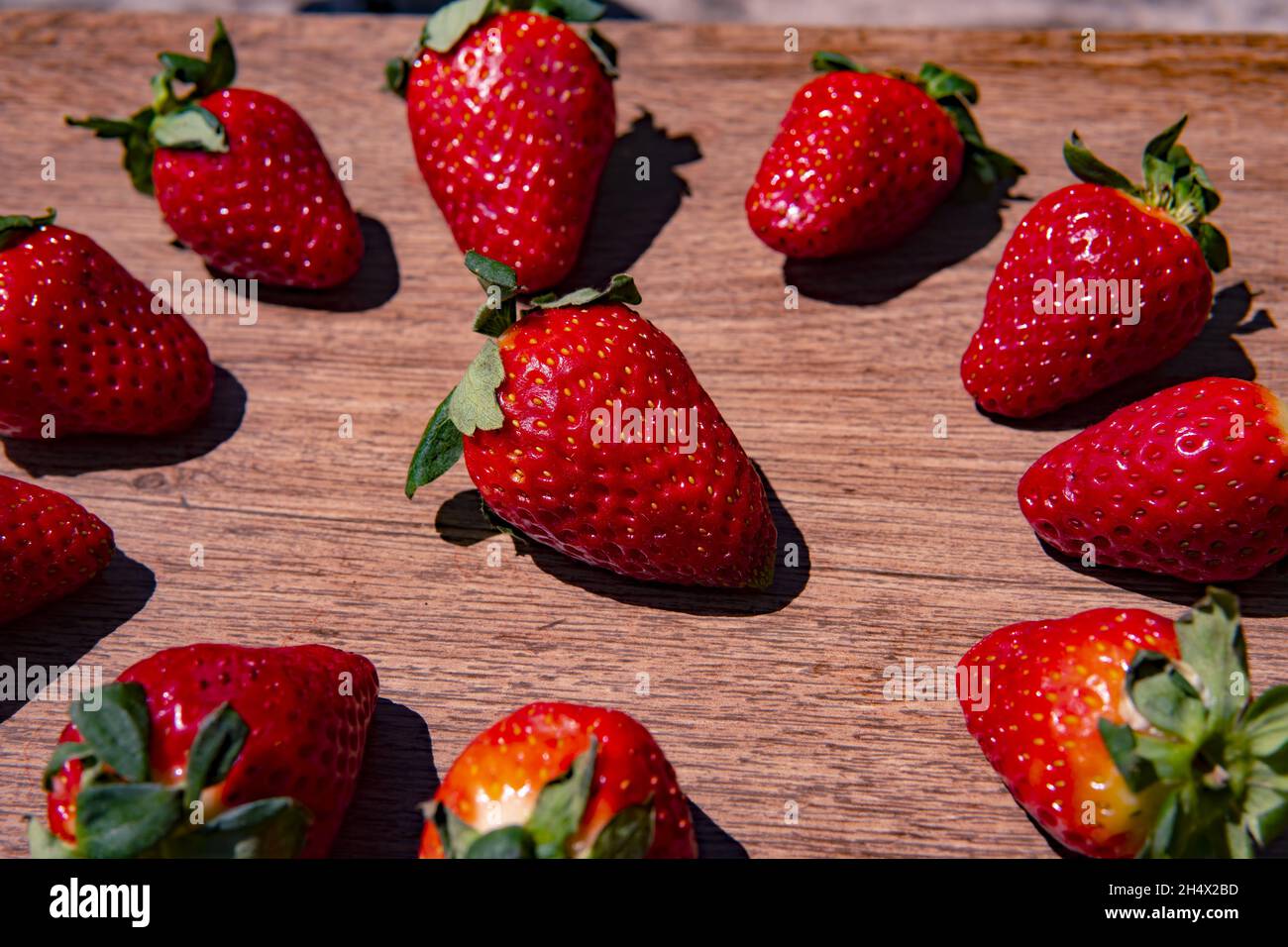 Bunch of fresh red strawberries drying on a wooden surface Stock Photo ...