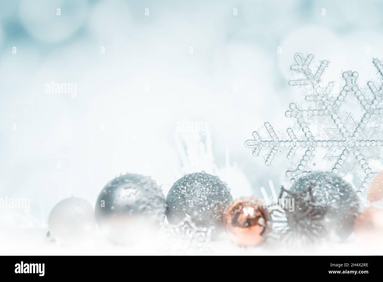 White and blue christmas background with balls in the snow and stars ...