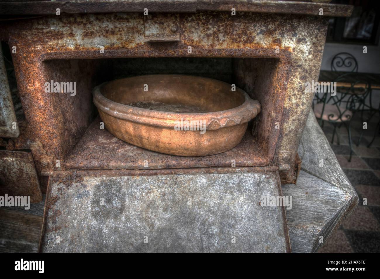 A vintage baking dish and an old stove Stock Photo