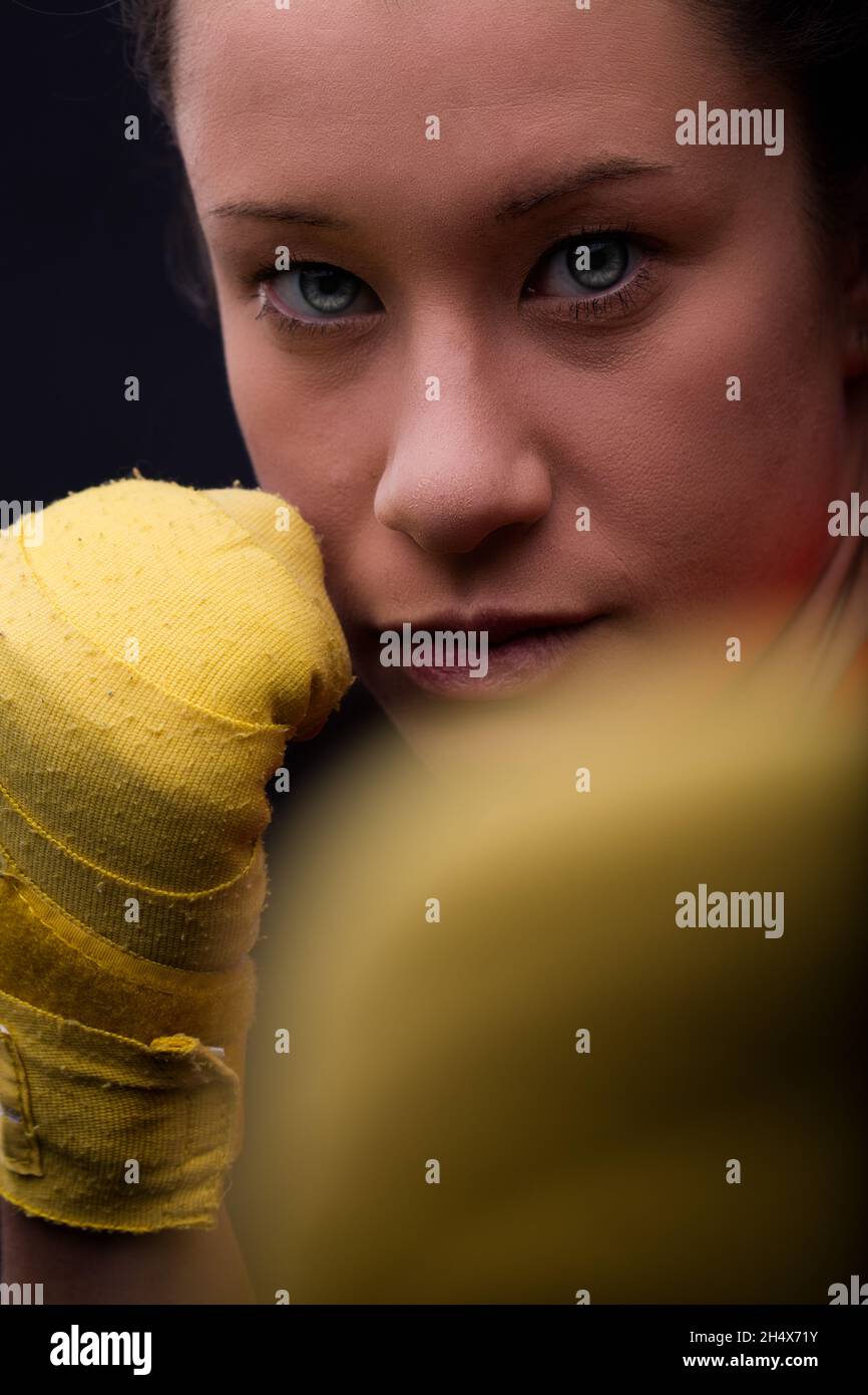 Closeup portrait of a woman boxer in fighting position. Beautiful
